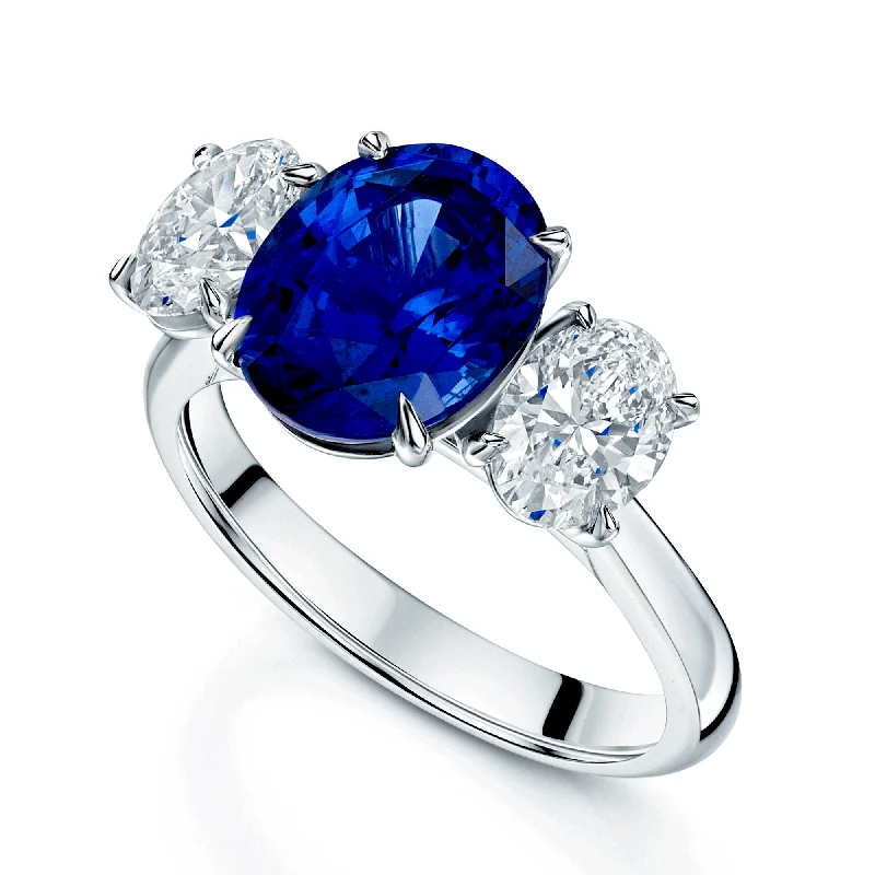 Engagement rings with a vintage style for women-Platinum Oval Cut Sapphire And Diamond Three Stone Ring