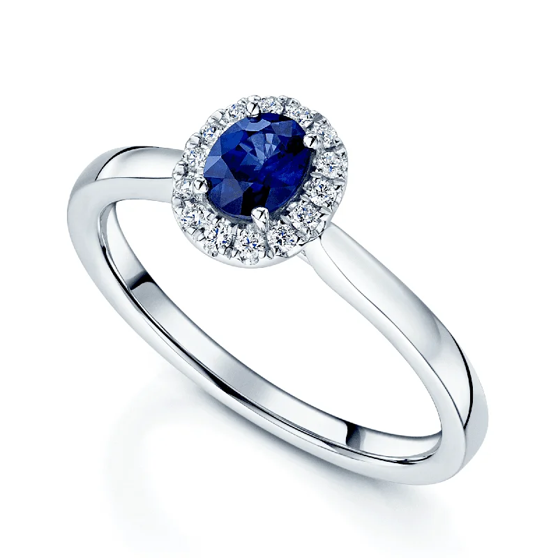 Heart shaped engagement rings for women-Platinum Oval Sapphire And Diamond Halo Ring