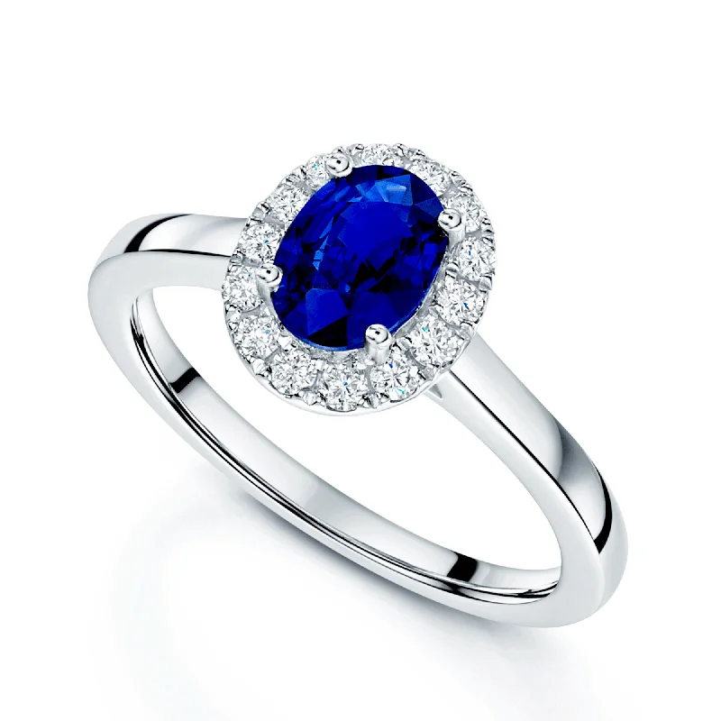 Three stone engagement rings for women-Platinum Oval Cut Sapphire And Diamond Cluster Ring